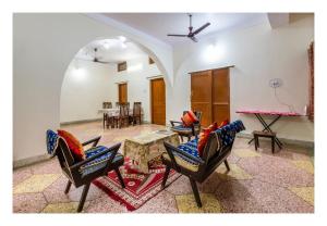 a living room with chairs and a table at Jaiswal Homestay Pet friendly Entire Bungalow in Jabalpur