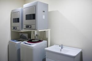 a bathroom with two computer monitors on top of a sink at Grace Hotel in Taipei