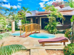 a villa with a pool and a house at Casa Jeri in Jericoacoara
