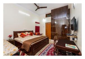 a bedroom with a bed and a tv in it at Jaiswal Homestay Pet friendly Entire Bungalow in Jabalpur