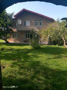a house in a yard with a grassy yard at Rooftop apartment with a big garden in Kocaeli