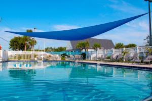a large swimming pool with a blue covering over it at Southern Oaks Inn - Saint Augustine in St. Augustine