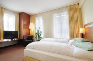 Postel nebo postele na pokoji v ubytování Hansa Apart-Hotel Regensburg + 24 fotografií