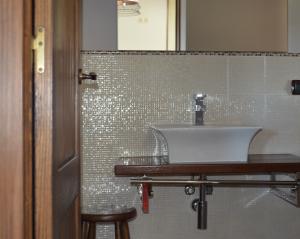 a bathroom with a white sink and a mirror at Airiños de Mondariz in Mondariz +55 photos