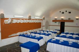 a room with blue and white tables and chairs at Hotel Hacienda Vista Hermosa in Tequesquitengo +103 photos