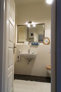 a bathroom with a sink and a mirror and a toilet at Adorable, cosy apartment at the Heroes' Square Budapest in Budapest