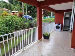 a porch of a house with a washing machine at RELAX superbe appartement avec vue imprenable in Bois la Charles
