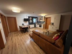 a living room with a couch and a table at Apartments Chalet Sonnentanz in Piesendorf