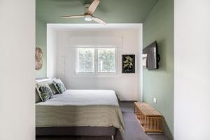 a bedroom with a bed and a ceiling fan at LOUXORY ACCOMODATION CAGLIARI in Cagliari