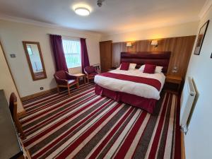 a hotel room with a bed and a large rug at The Royal Hotel in Liverpool