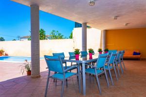 a table and chairs on a patio with a pool at 039 Casa Marimar ETV8486 by Mallorca Charme in Muro