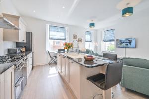 a kitchen with a large island in the middle at The Falstone Apartment in Torquay