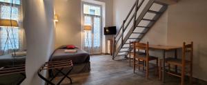 Zimmer mit einer Treppe, einem Bett und einem Tisch in der Unterkunft STUDIOS PARISIENS in Cannes