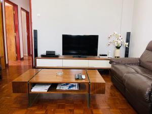 a living room with a couch and a coffee table at Januario Maputo in Maputo