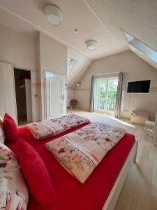 a large bedroom with two beds and a tv at Ferienwohnung Bodensee in Überlingen