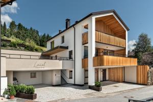 an exterior view of a building with a balcony at Silent Luxury Chalet LAIET in San Valentino alla Muta