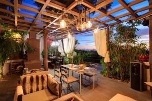 a patio with a table and chairs and plants at Marbella Boutique Art suites in Marbella