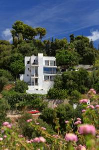a white house on a hill with trees and flowers at Marbella Boutique Art suites in Marbella