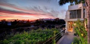 a sunset view of a house with a balcony at Marbella Boutique Art suites in Marbella
