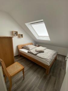 a bedroom with a bed and a skylight at Ferienhaus Xantenamera in Xanten-Wardt am See in Xanten