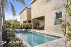 a swimming pool in front of a house at 520-Villa by Disney 8 Bedrooms wPool & SPA in Orlando