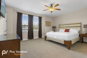 a bedroom with a bed and a ceiling fan at 520-Villa by Disney 8 Bedrooms wPool & SPA in Orlando
