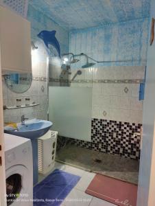 a small bathroom with a sink and a shower at Luketo in Vieux-Habitants