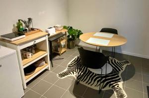 a table and a zebra chair in a kitchen at Studio Just For 2 in Ostend