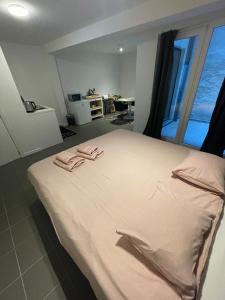 a bedroom with a bed with two towels on it at Studio Just For 2 in Ostend +4 photos
