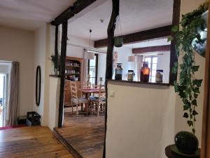 a living room with a refrigerator and a dining room at Grande maison de montagne rénovée, du charme in Rodome