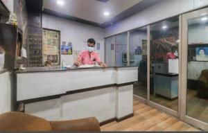 a man with a face mask standing at a counter at HOTEL Royal Plaza in Chandīgarh
