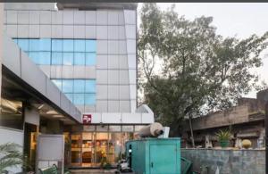 a large glass building with a building at HOTEL Royal Plaza in Chandīgarh
