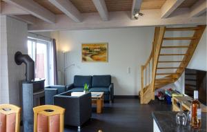 a living room with a couch and a staircase at Beautiful Home In Nordhorn With Kitchen in Nordhorn