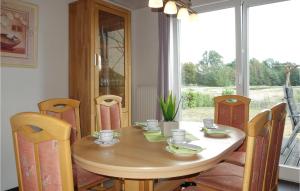 a dining room table and chairs with a table and a window at Beautiful Home In Nordhorn With Kitchen in Nordhorn