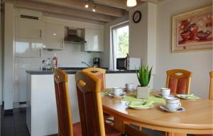 a kitchen and dining room with a wooden table at Beautiful Home In Nordhorn With Kitchen in Nordhorn