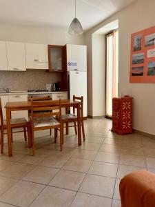 a kitchen and dining room with a table and chairs at Da Giusy in Stresa