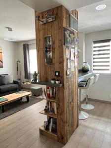 a living room with a wooden partition with a book shelf at Lovely Studio Cannes in Cannes