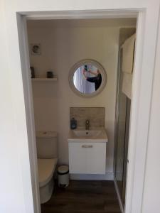 a person taking a picture of a bathroom with a mirror at Wick Studio in Christchurch
