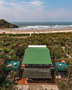 an overhead view of a beach with a green roof at Grajagan Surf Resort in Ilha do Mel