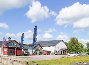 a group of buildings with cars parked in a parking lot at Tofta Konstgalleri-Familjelägenhet in Varberg