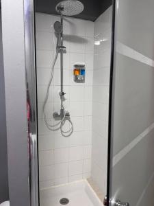 a shower in a bathroom with a glass door at Travel Escape in Cayenne
