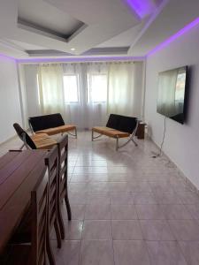 a room with two chairs and a flat screen tv at Appart Hotel Belvedere in Praia