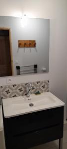 a bathroom with a sink and a mirror at Appartement 6 personnes station de ski Val Louron in Val Louron