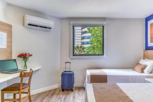 Postel nebo postele na pokoji v ubytování Cais da Praia Hotel