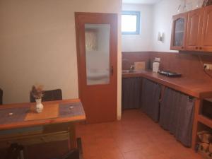 a kitchen with a door and a table and a counter at Sklep U Petra in Velké Bílovice