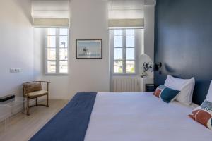 - une chambre avec un grand lit et 2 fenêtres dans l'établissement Les Séraphines - Chambres d'hôtes - Guests house, à Bordeaux