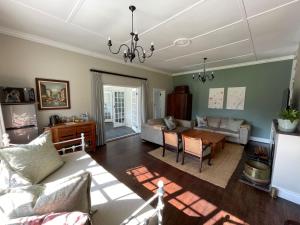 a living room with a couch and a table at Protea Manor in George