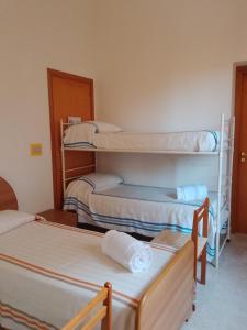 a room with three bunk beds in it at L'Albero Amico in Racalmuto