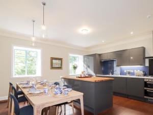 a kitchen with a table with chairs and a dining room at Inverewe - House Apartment in Achnasheen