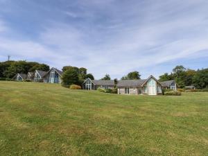 a row of houses on a large grass field at Swandown, 2 Blackdown in Chard